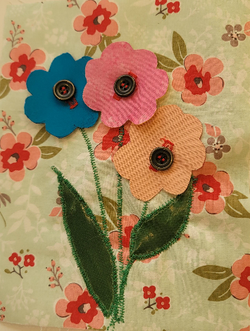 3 flowers on floral backing